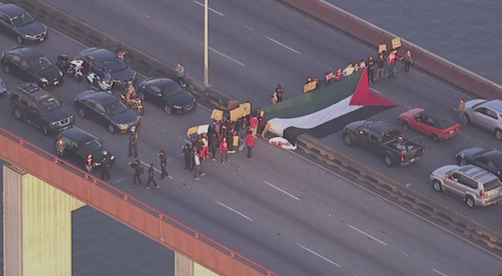 Stanford students protesting on the San Mateo Bridge. Photo credit: http://smpalestine.com/2015/01/19/stanford-students-stage-civil-disobedience-shut-down-bridge/